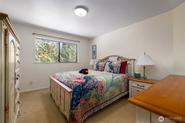 a bathroom with a granite countertop sink mirror and toilet