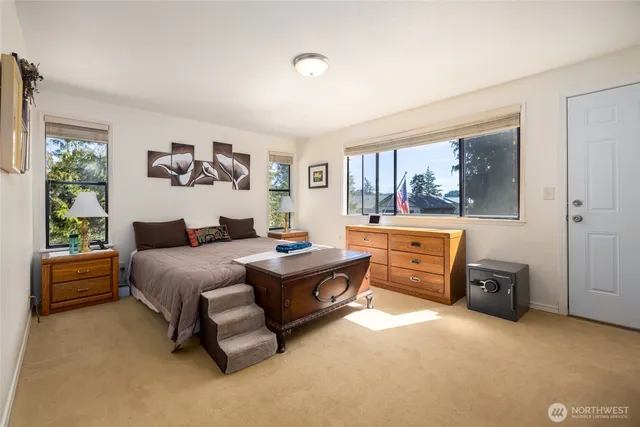 a bedroom with a bed and a large window