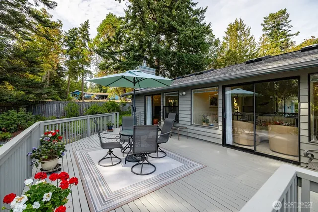 a view of a patio with couches table and chairs and potted plants