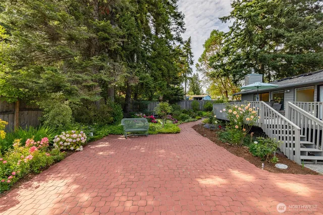 a view of a house with a yard and tree