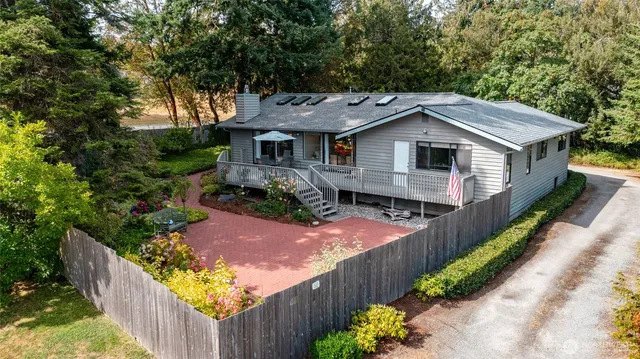a front view of a house with yard and green space