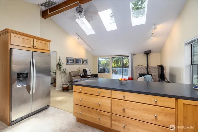 a kitchen with stainless steel appliances granite countertop a stove a sink and a microwave