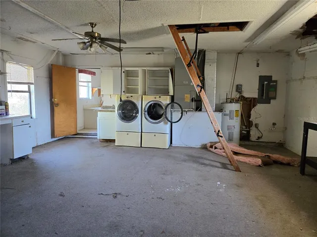 a kitchen with granite countertop a sink window and cabinets