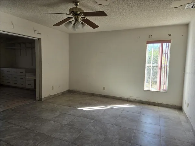 a view of a livingroom with a ceiling fan and entryway