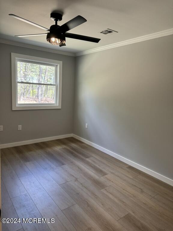 57 A Sunset Road Whiting, NJ 08759 - Photo 15 of 29 an empty room with wooden floor fan and windows