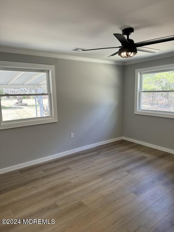 57 A Sunset Road Whiting, NJ 08759 - Photo 18 of 29 an empty room with wooden floor fan and windows