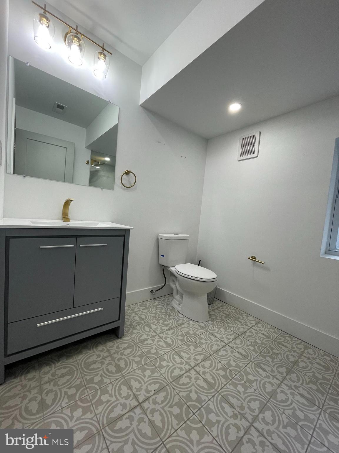 1205 South 4th Street, Unit 2 Philadelphia, PA 19147 - Photo 6 of 12 a bathroom with a toilet sink and mirror
