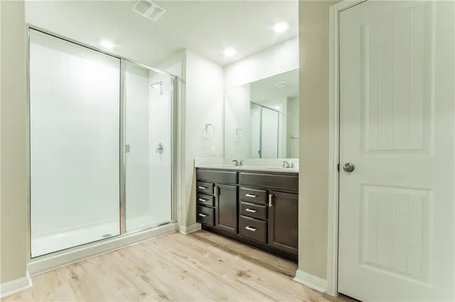 a bathroom with a double vanity sink shower and a mirror