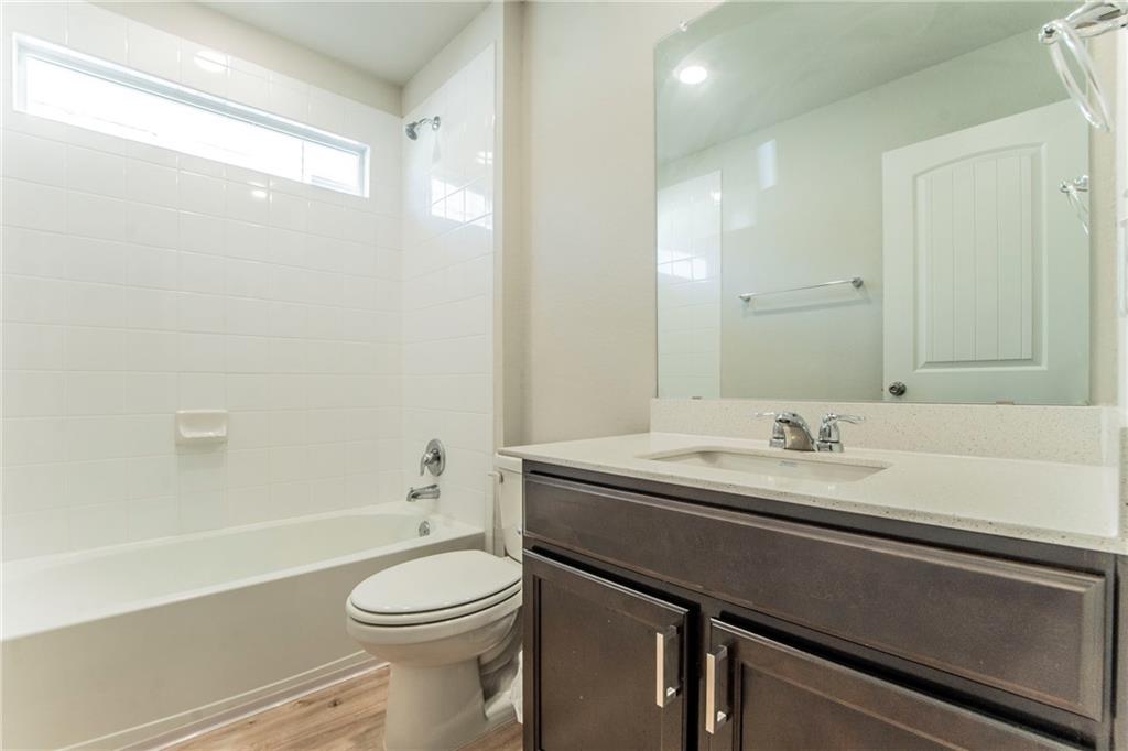172 Arrowhead Vine Street Leander, TX 78641 - Photo 16 of 21 a bathroom with a sink a toilet and a mirror