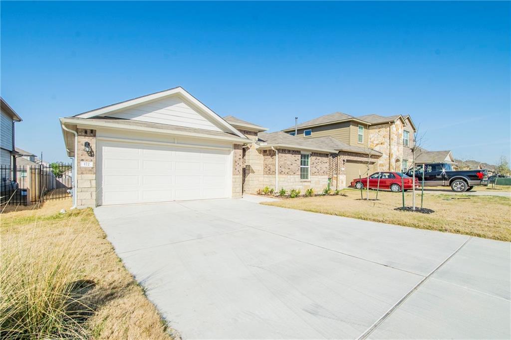 172 Arrowhead Vine Street Leander, TX 78641 - Photo 17 of 21 a view of an house with backyard and parking