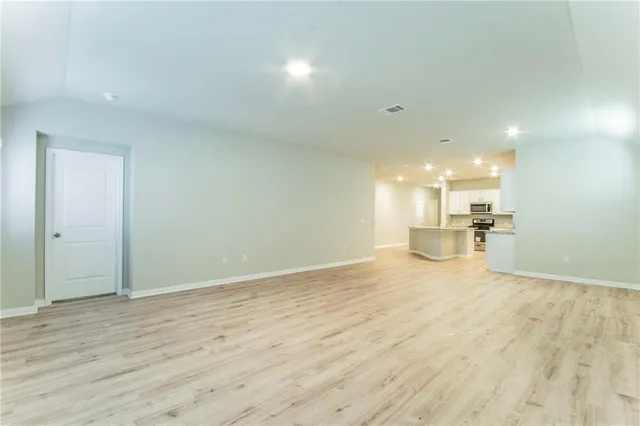 a view of a kitchen with a sink and wooden floor