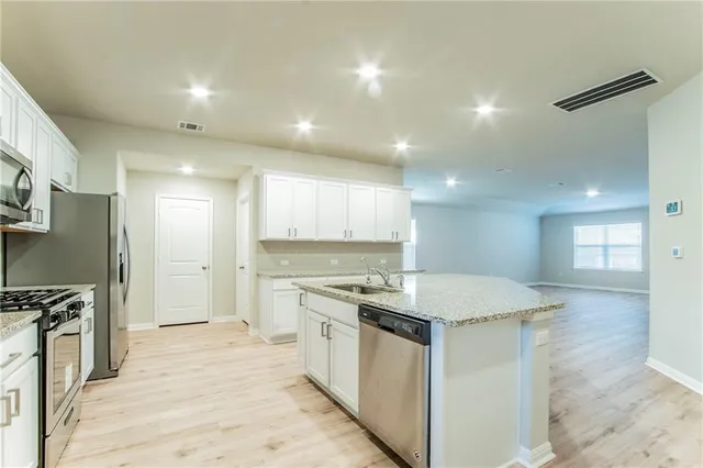 a kitchen with a stove a sink and a refrigerator