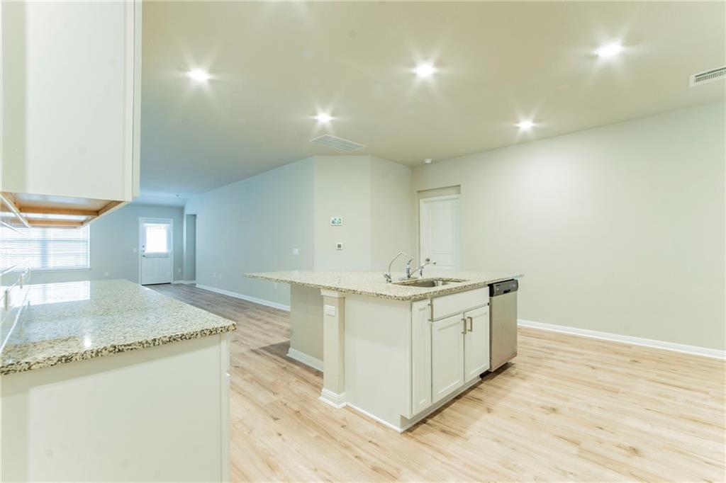 172 Arrowhead Vine Street Leander, TX 78641 - Photo 8 of 21 a spacious bathroom with a granite countertop sink and a mirror