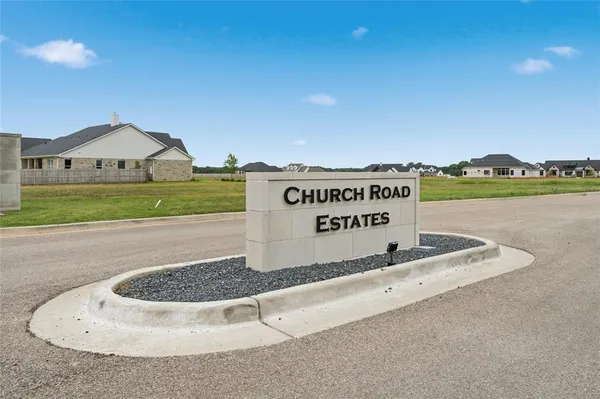a view of a sign in front of house