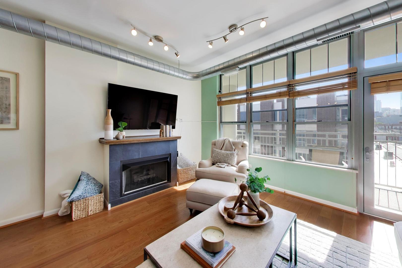 1200 West Monroe Street, Unit 502 Chicago, IL 60607 - Photo 3 of 34 a living room with furniture flat screen tv and a fireplace