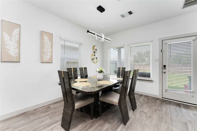 a view of a dining room with furniture and wooden floor