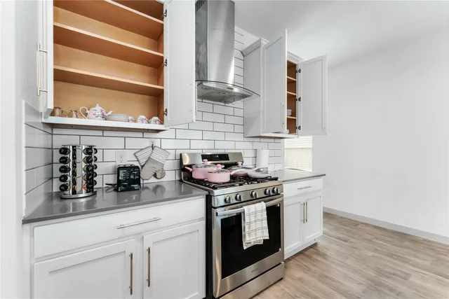 a kitchen with stainless steel appliances granite countertop a stove and a sink