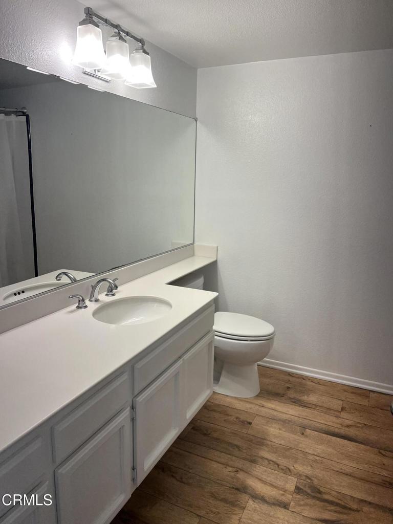4510 Antigua Way Oxnard, CA 93035 - Photo 14 of 16 a bathroom with a toilet a sink and mirror