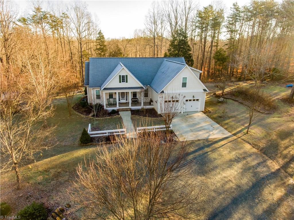 371 Foulks Road Madison, NC 27025 - Photo 4 of 30 Nestled on 24 acres, this home has cleared yard and gardening areas.