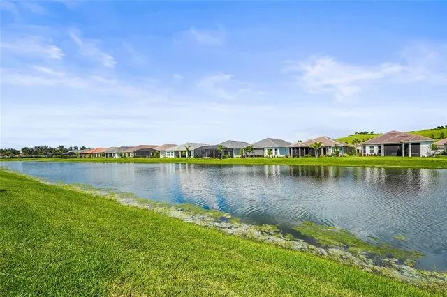 a view of a backyard with a patio table and chairs under an umbrella
