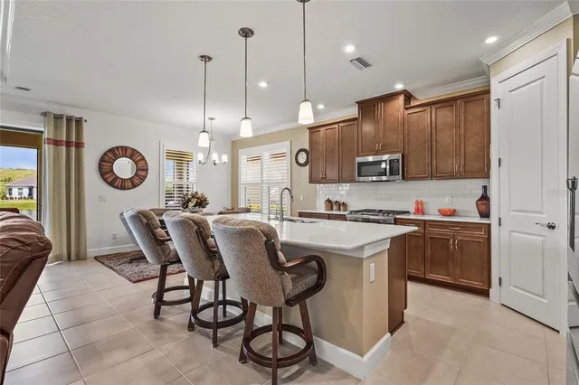 a spacious bathroom with a double vanity sink a toilet a mirror and shower