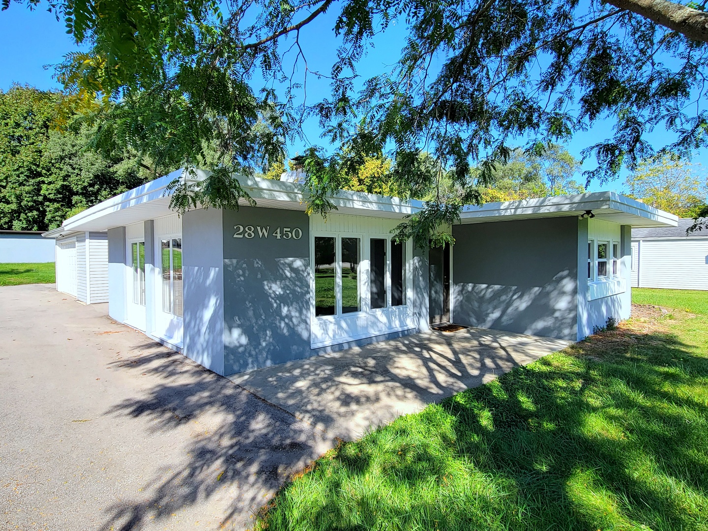 a front view of a house with a garden and yard