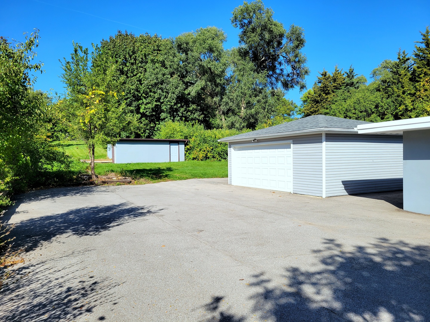 28W450 Roosevelt Road Winfield, IL 60190 - Photo 19 of 28 a view of a house with a yard and garage