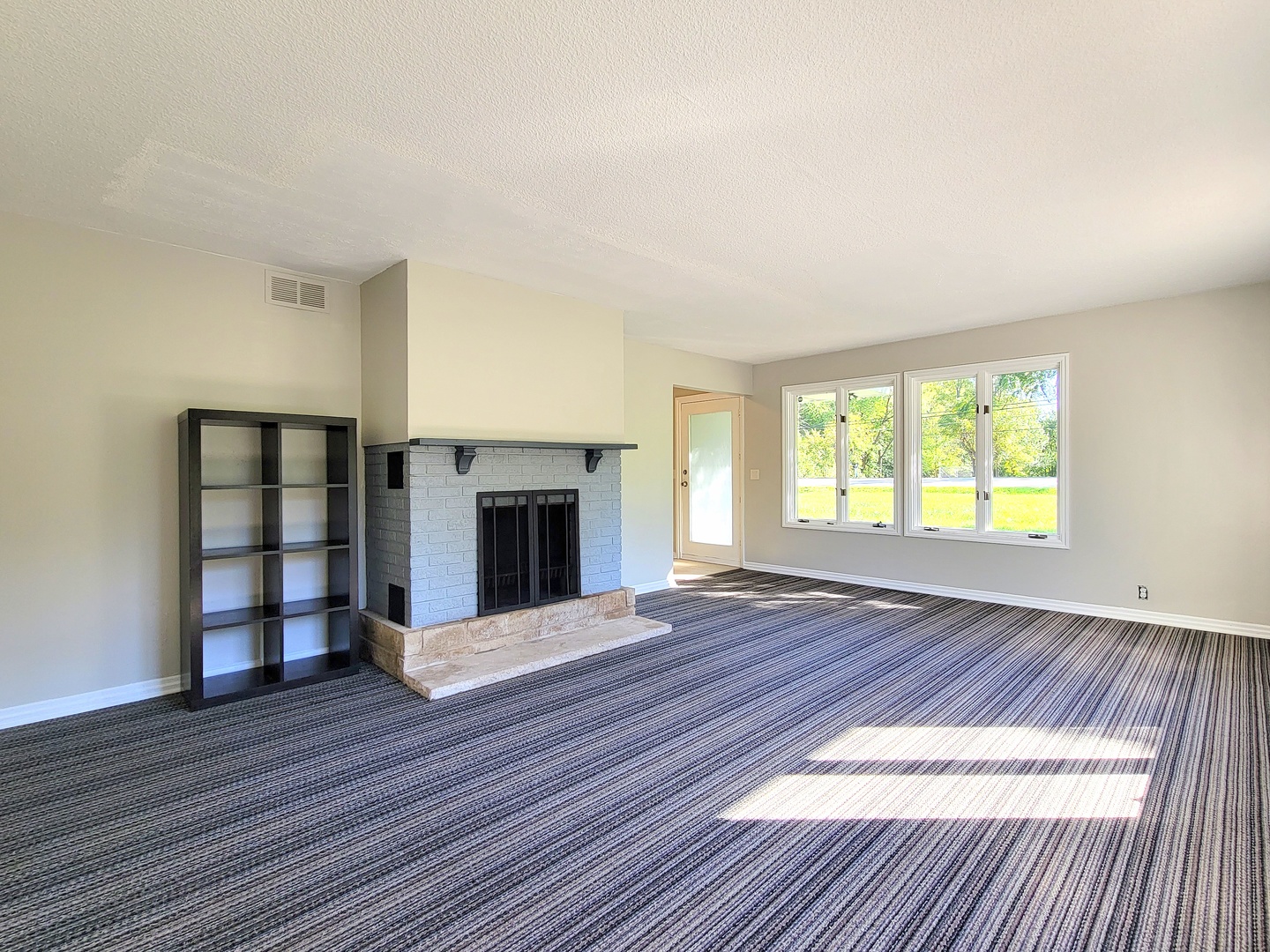 28W450 Roosevelt Road Winfield, IL 60190 - Photo 2 of 28 an empty room with wooden floor fireplace and windows
