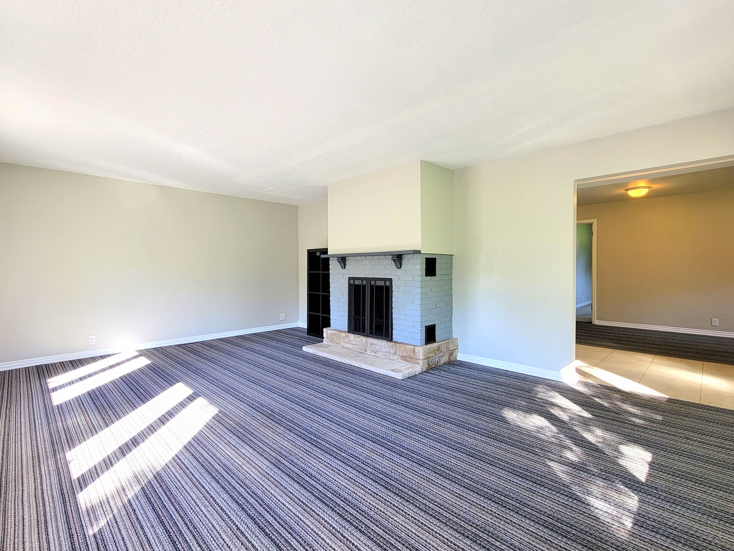 28W450 Roosevelt Road Winfield, IL 60190 - Photo 4 of 28 a view of empty room with wooden floor and fireplace