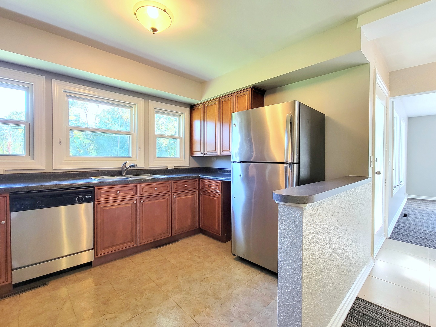 28W450 Roosevelt Road Winfield, IL 60190 - Photo 8 of 28 a kitchen with granite countertop a refrigerator and a sink