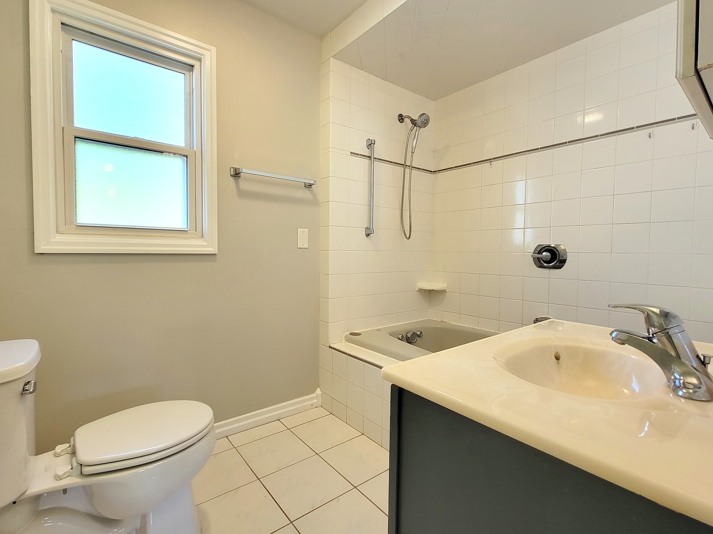 28W450 Roosevelt Road Winfield, IL 60190 - Photo 10 of 28 a bathroom with a sink a toilet and shower