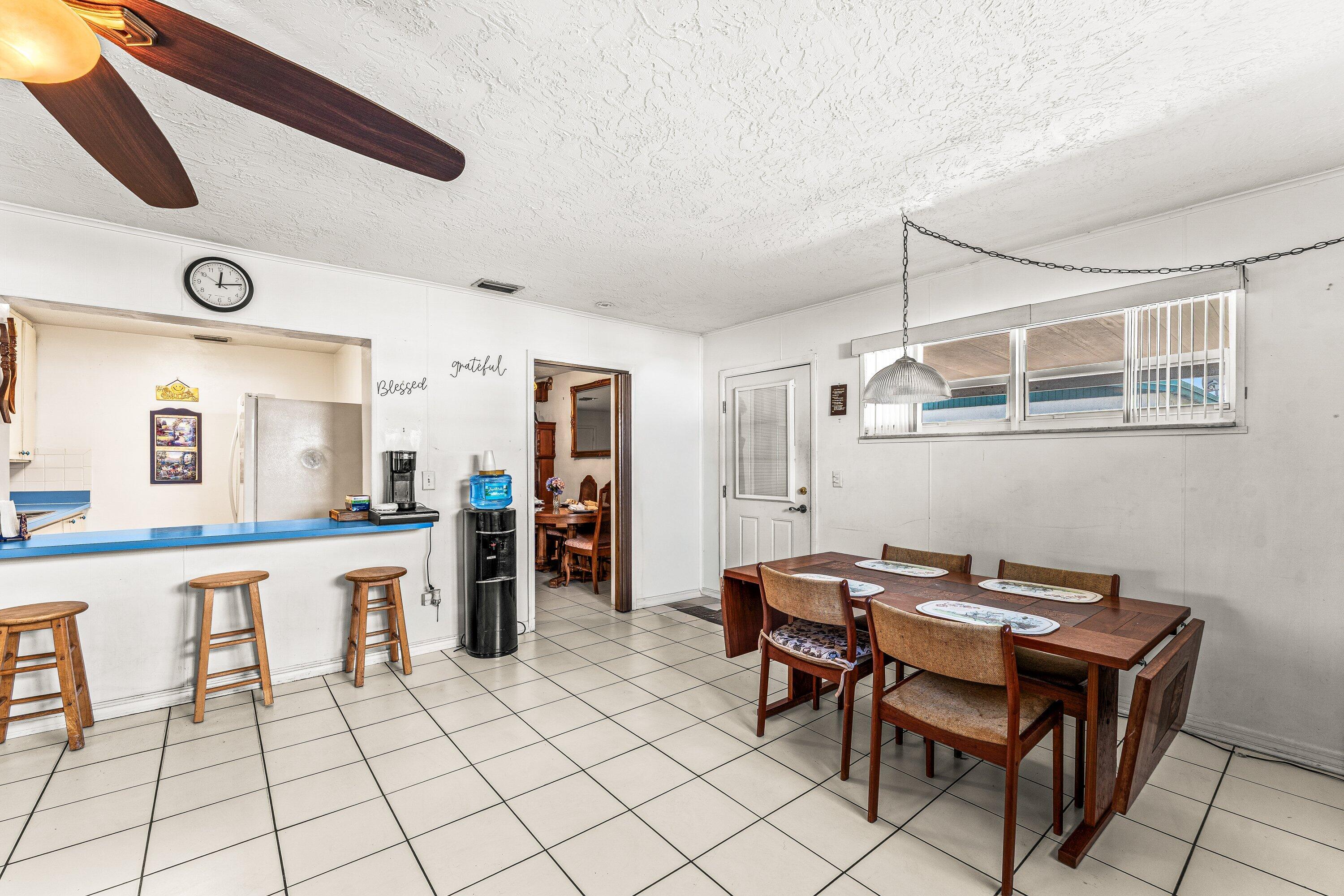 1040 West 1st Street Riviera Beach, FL 33404 - Photo 14 of 26 a room with furniture a table and chairs