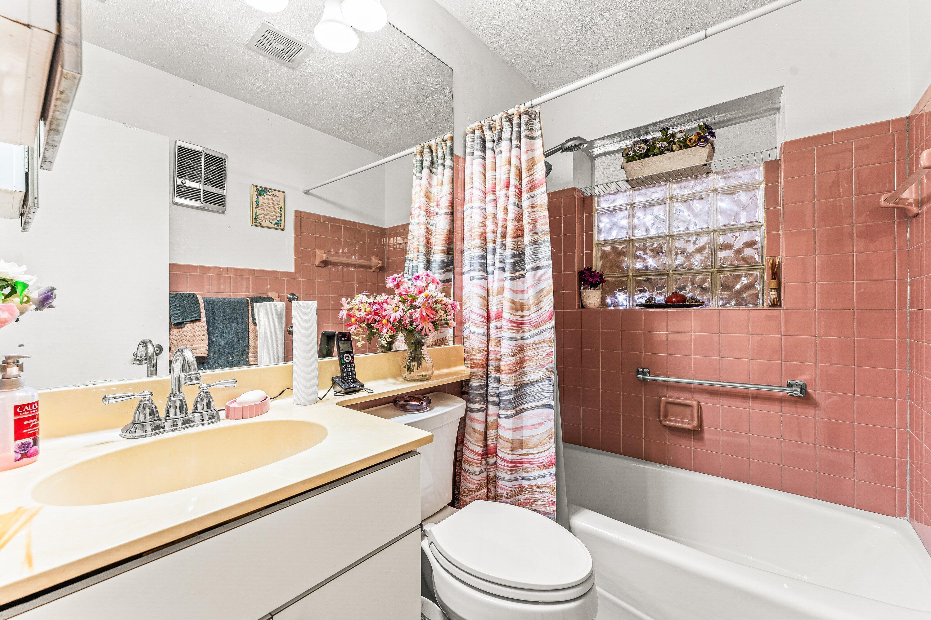 1040 West 1st Street Riviera Beach, FL 33404 - Photo 17 of 26 a bathroom with a sink a toilet and shower