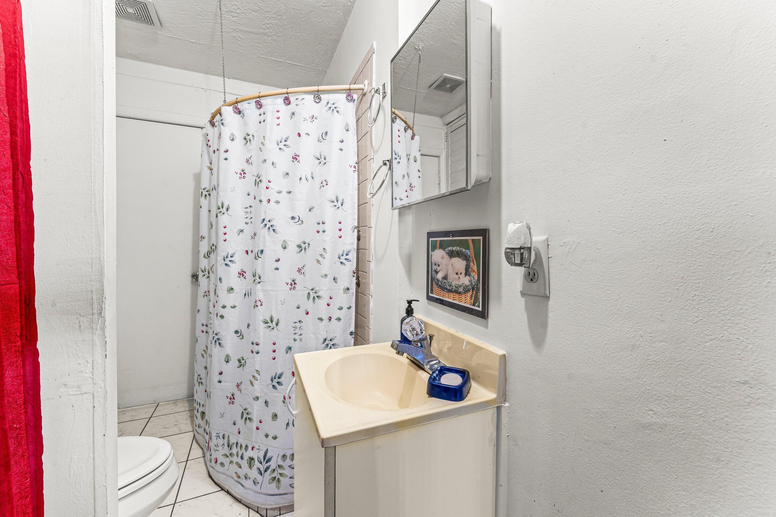 1040 West 1st Street Riviera Beach, FL 33404 - Photo 20 of 26 a bathroom with a sink toilet and shower
