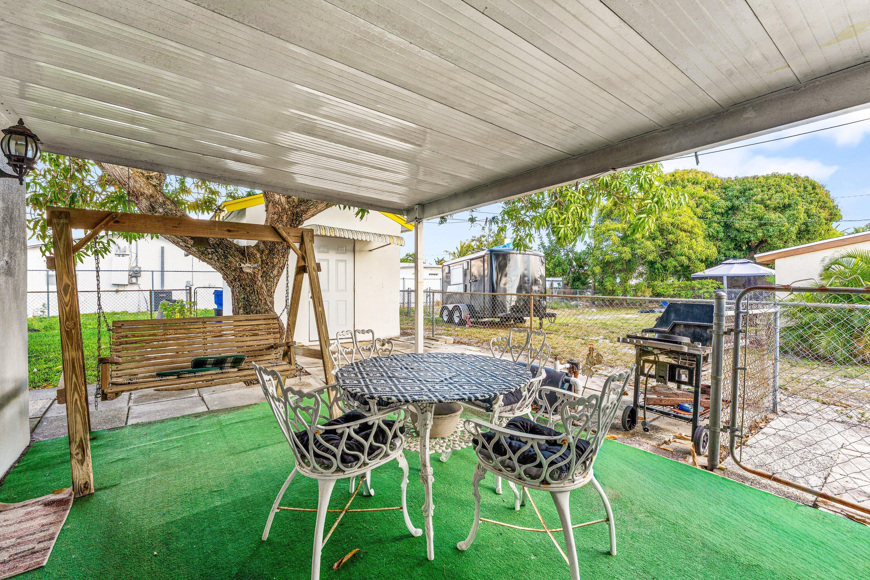 1040 West 1st Street Riviera Beach, FL 33404 - Photo 25 of 26 a view of an outdoor sitting area with furniture and garden view