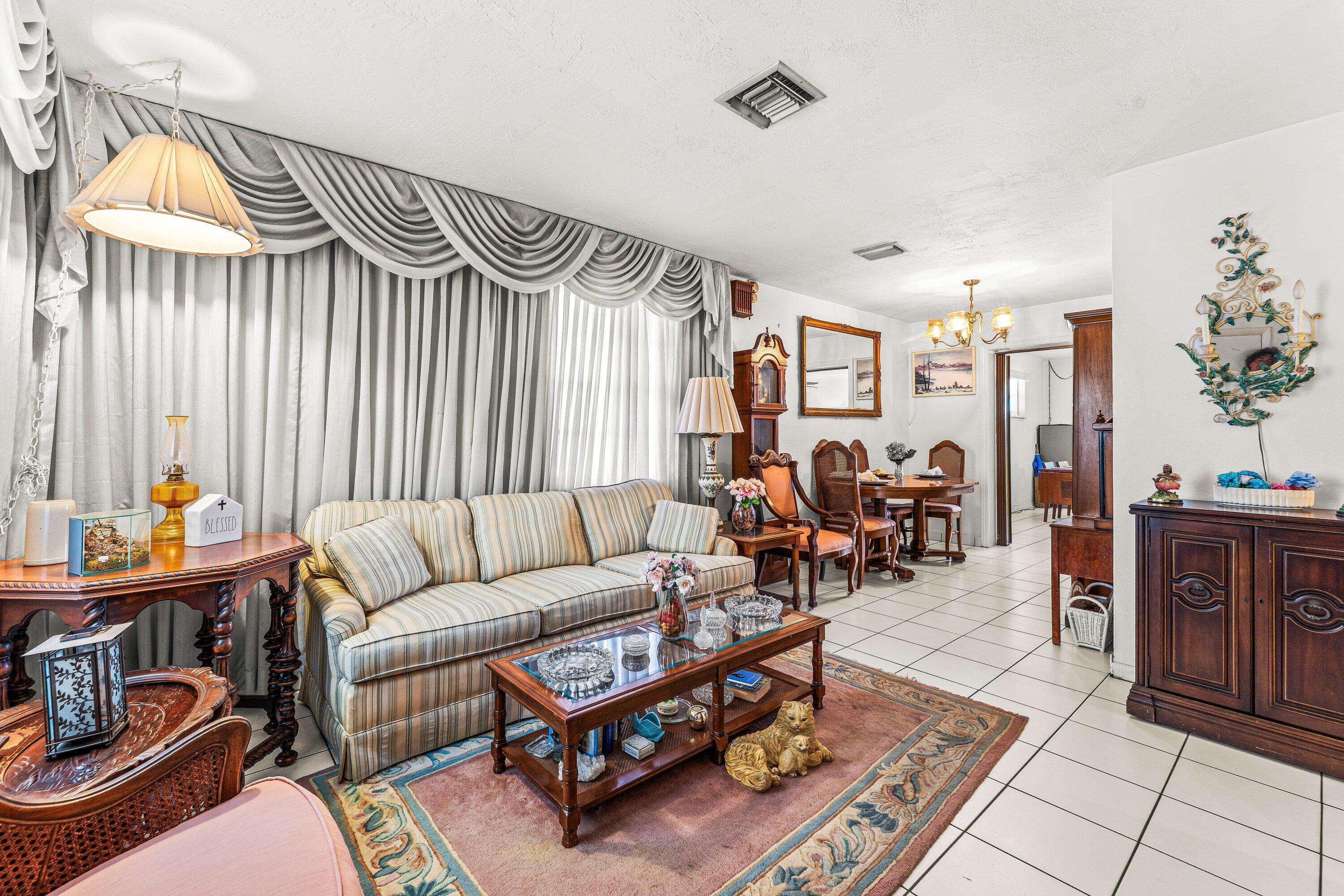 1040 West 1st Street Riviera Beach, FL 33404 - Photo 4 of 26 a living room with furniture and a chandelier