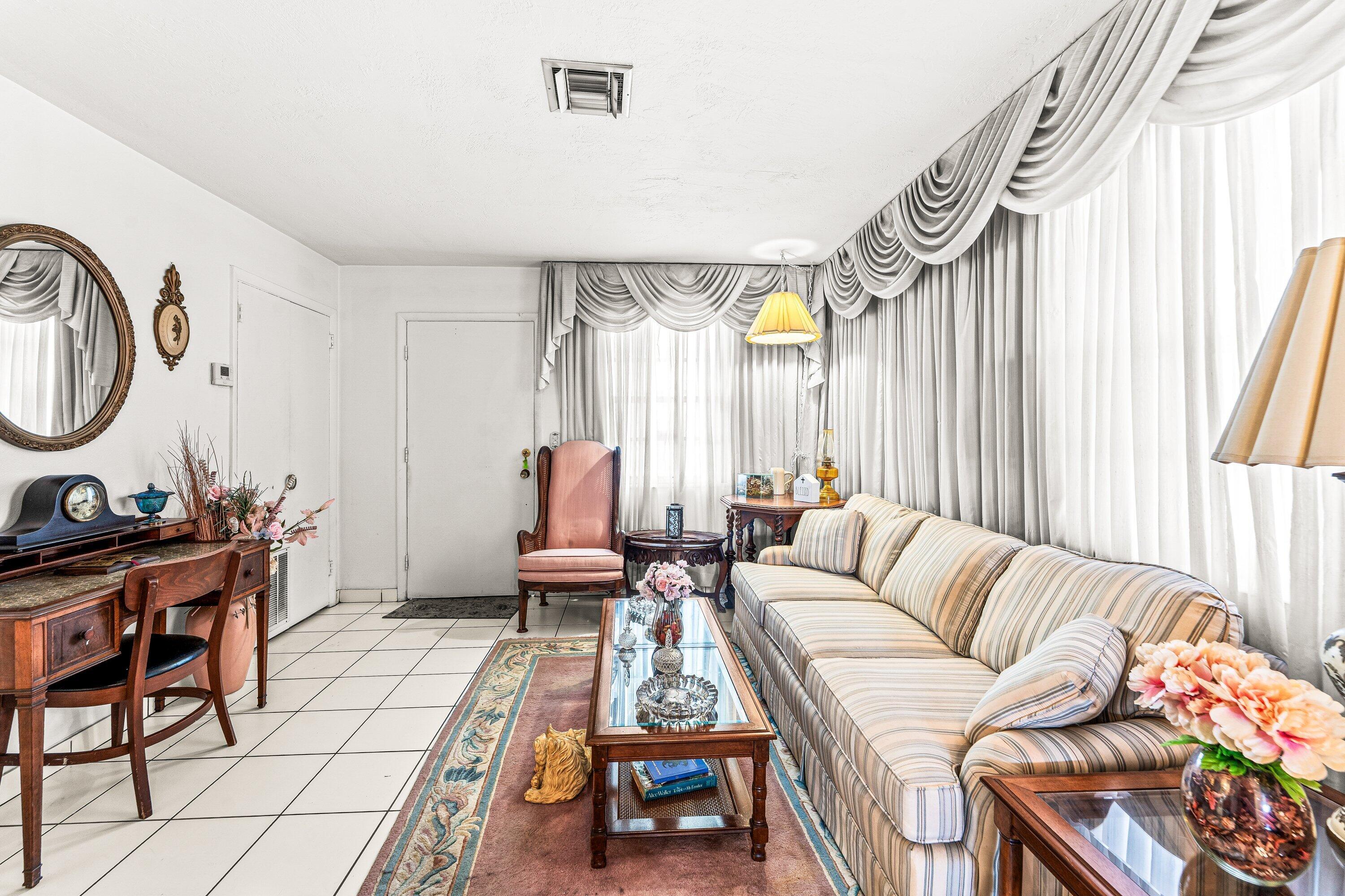 1040 West 1st Street Riviera Beach, FL 33404 - Photo 5 of 26 a living room with furniture and a window