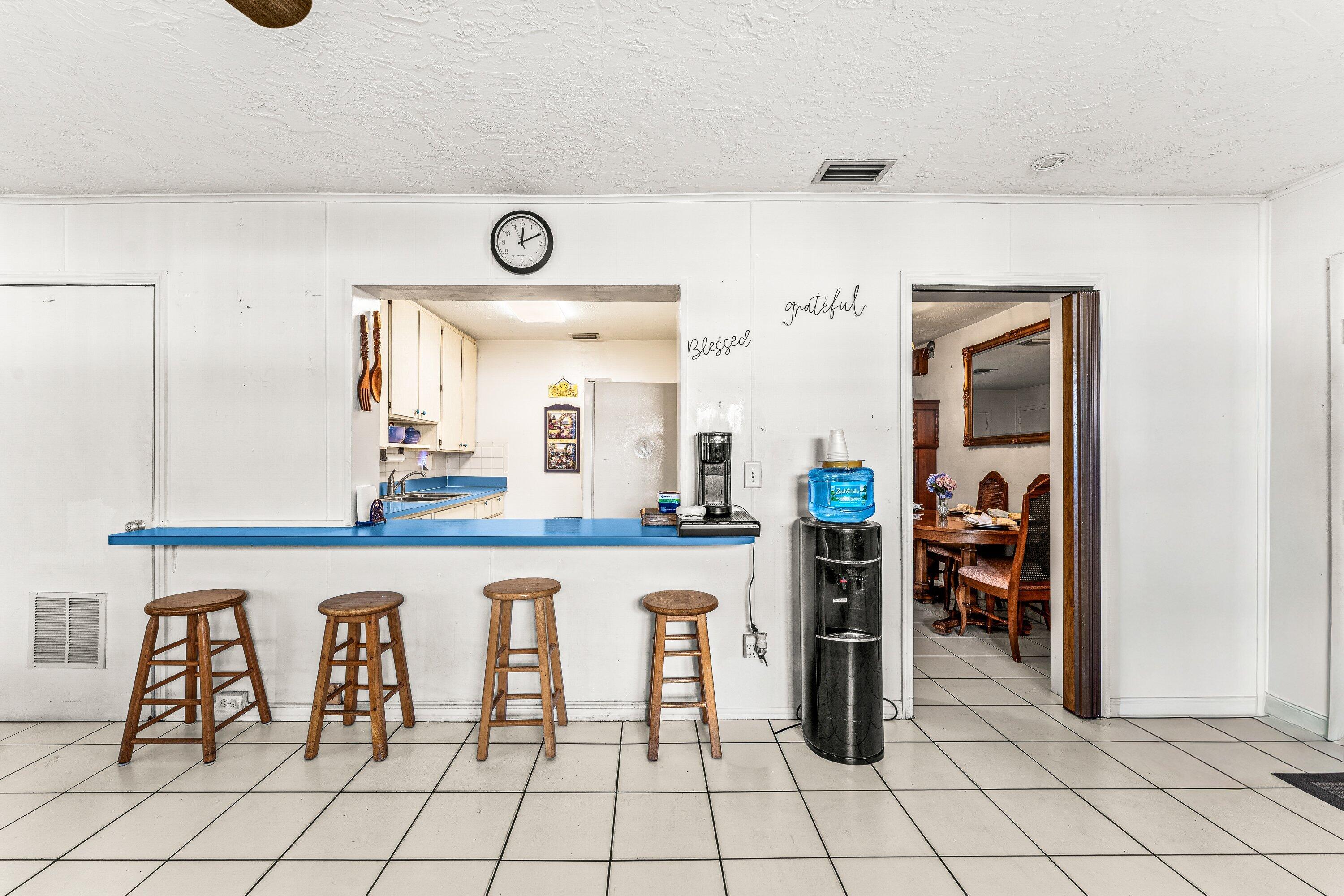 1040 West 1st Street Riviera Beach, FL 33404 - Photo 10 of 26 a kitchen with cabinets and chairs