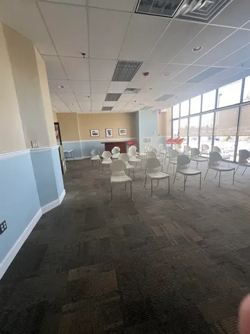 a living room with lots of furniture and a projector screen