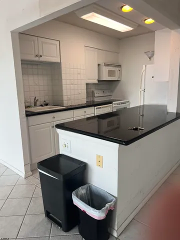 a kitchen with a sink a stove a microwave and cabinets