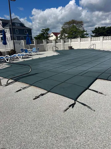 a view of swimming pool with outdoor seating and city view