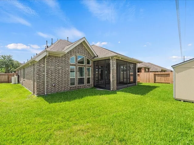 a view of backyard with potted plants and wooden fence