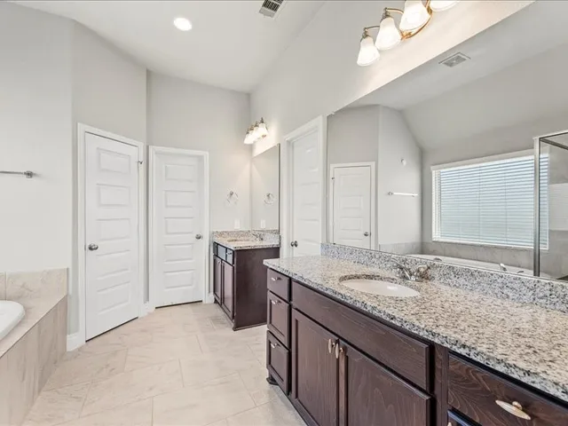 a white bath tub sitting next to a shower