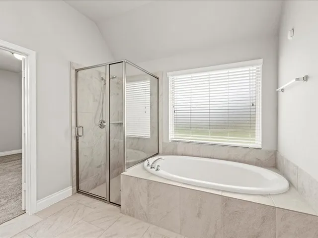 a bathroom with a tub a sink and mirrors
