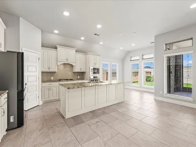 a large kitchen with cabinets