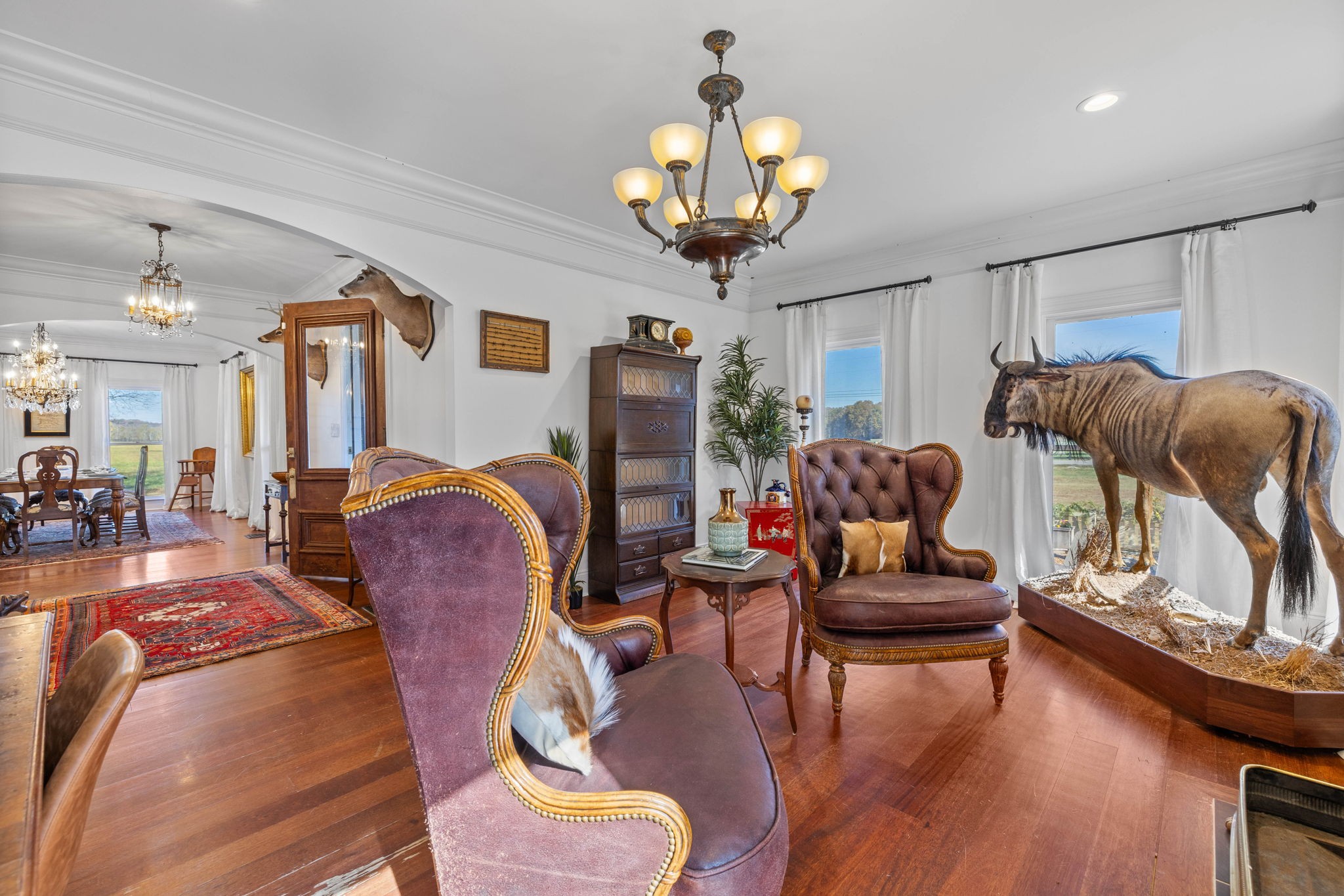 3111 Carl Road Franklin, TN 37064 - Photo 10 of 65 a living room with furniture a dining table and a chandelier