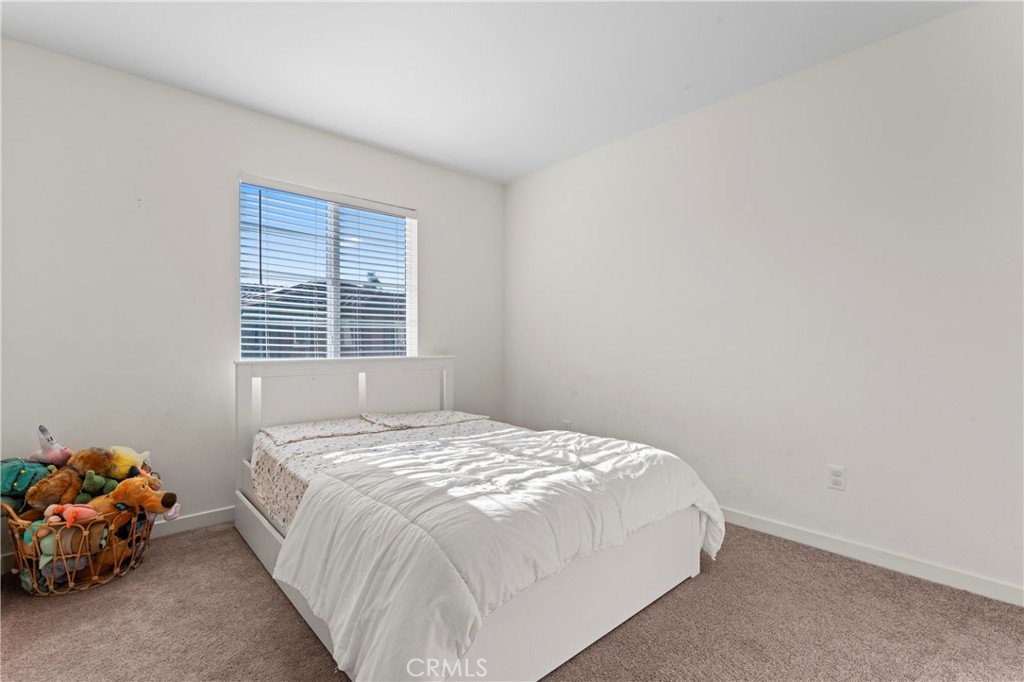 12704 Ironstone Way Moreno Valley, CA 92555 - Photo 11 of 38 a bedroom with a bed and a window
