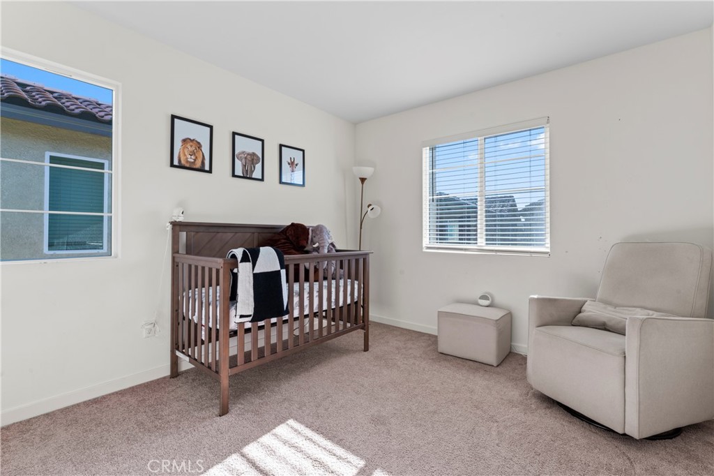 12704 Ironstone Way Moreno Valley, CA 92555 - Photo 12 of 38 a living room with furniture and a window