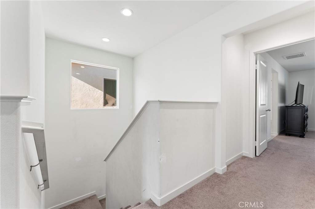 12704 Ironstone Way Moreno Valley, CA 92555 - Photo 13 of 38 a view of hallway with stairs