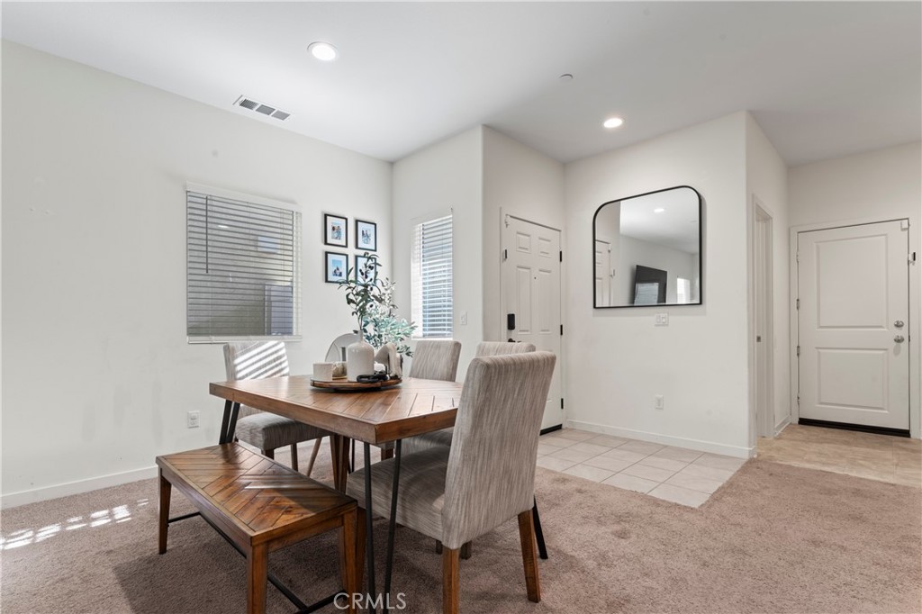 12704 Ironstone Way Moreno Valley, CA 92555 - Photo 19 of 38 a view of a dining room with furniture and wooden floor
